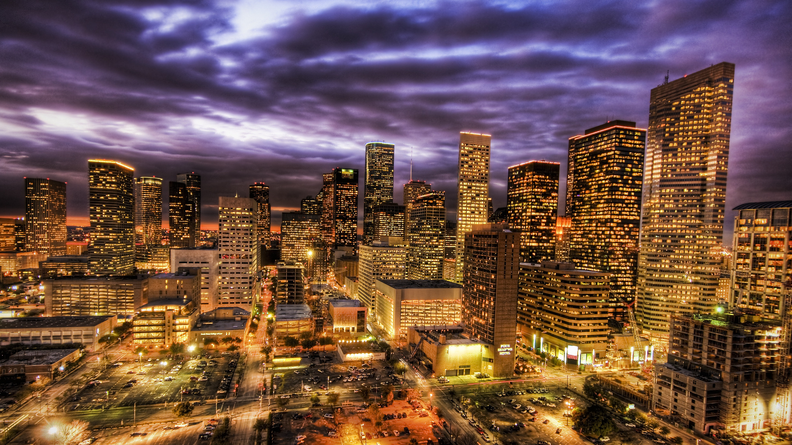 City Skyline Under Gray Clouds During Night Time. Wallpaper in 2560x1440 Resolution