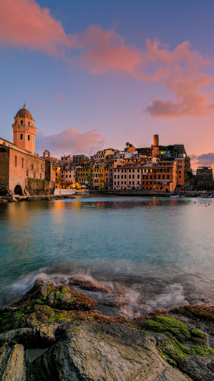 Brown Concrete Building Near Body of Water During Sunset. Wallpaper in 720x1280 Resolution