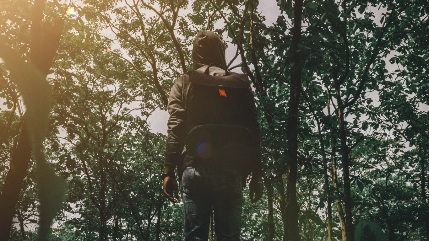 Man in Black Jacket and Black Pants Standing on Green Grass Field During Daytime. Wallpaper in 1366x768 Resolution