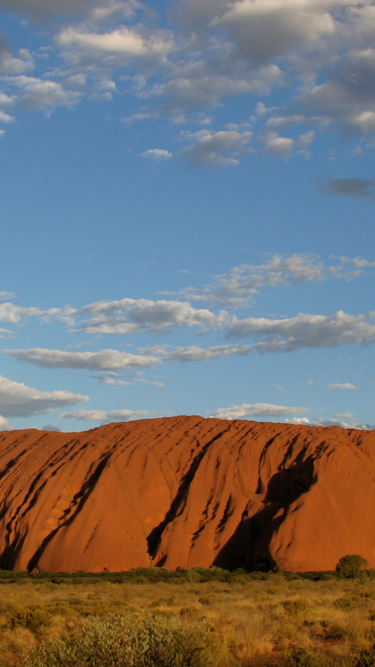 Brown Mountain Under Blue Sky During Daytime. Wallpaper in 750x1334 Resolution