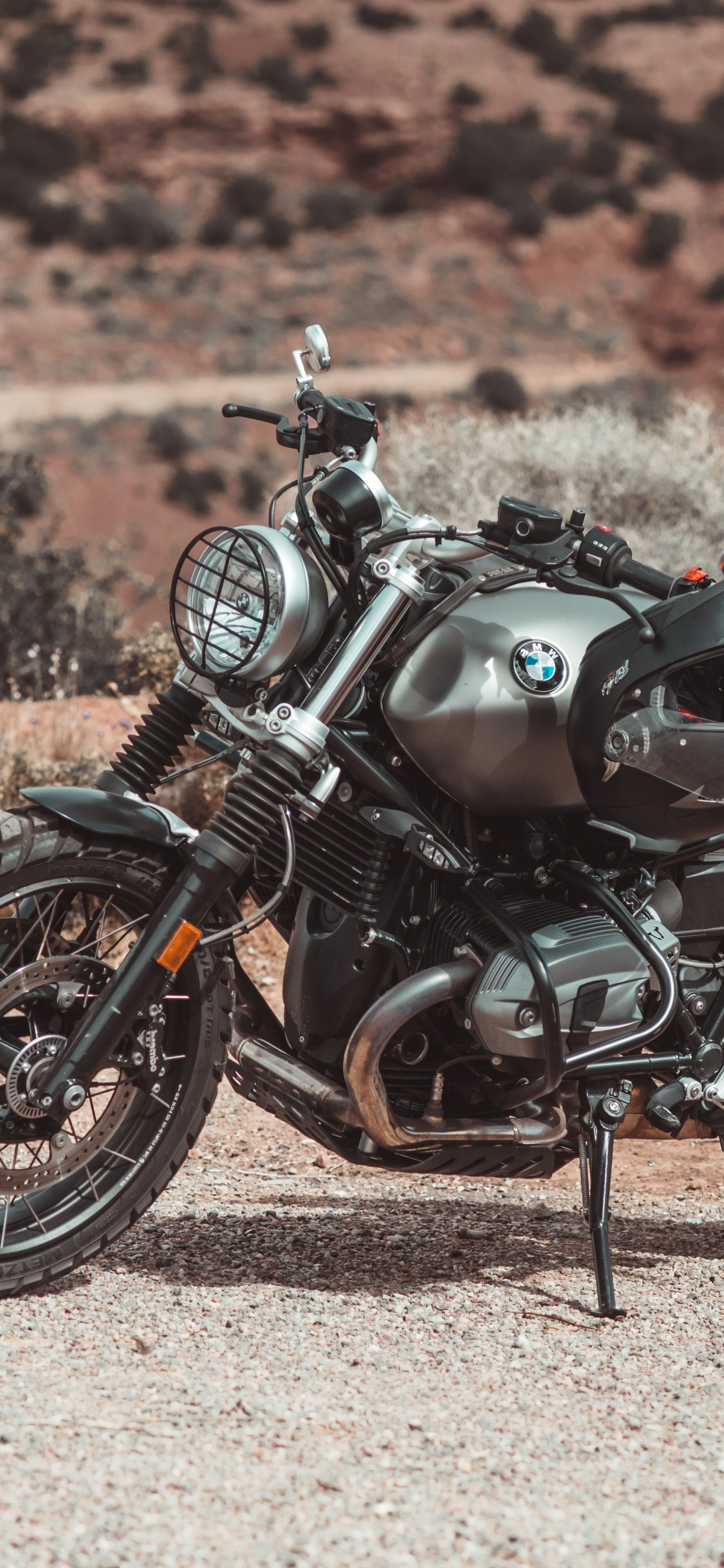 Black and Brown Motorcycle on Brown Sand During Daytime. Wallpaper in 1125x2436 Resolution