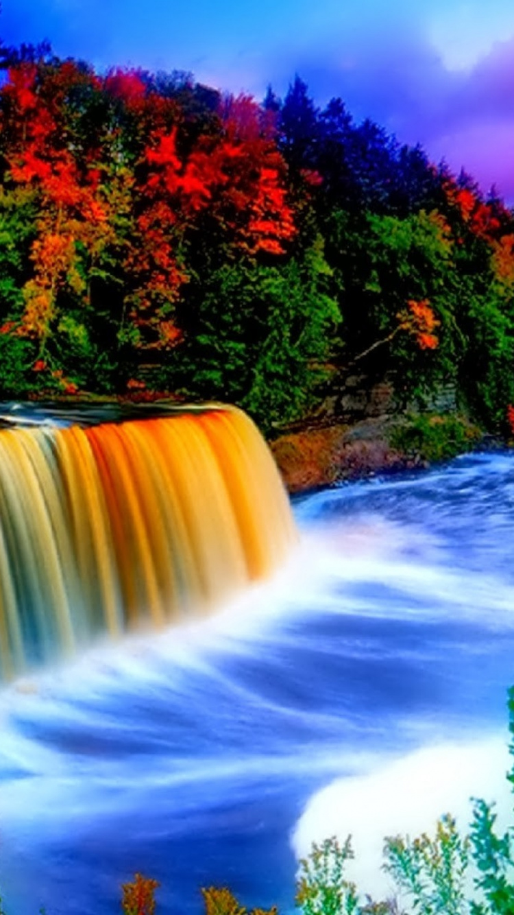 Water Falls Surrounded by Trees Under Blue Sky. Wallpaper in 750x1334 Resolution