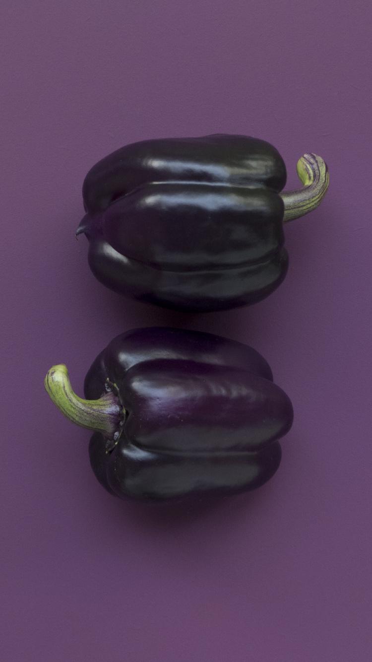 Black Bell Pepper on Purple Textile. Wallpaper in 750x1334 Resolution