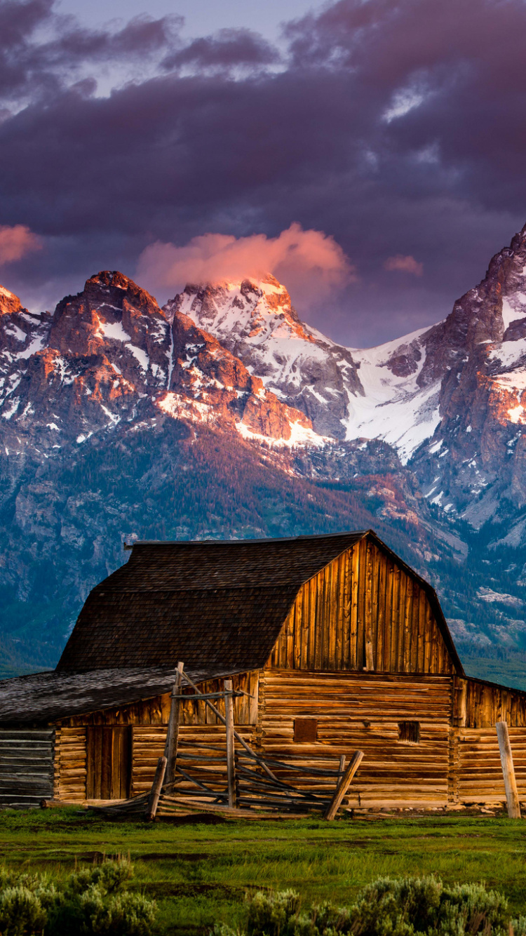 Brown Wooden Barn Near Snow Covered Mountain. Wallpaper in 750x1334 Resolution