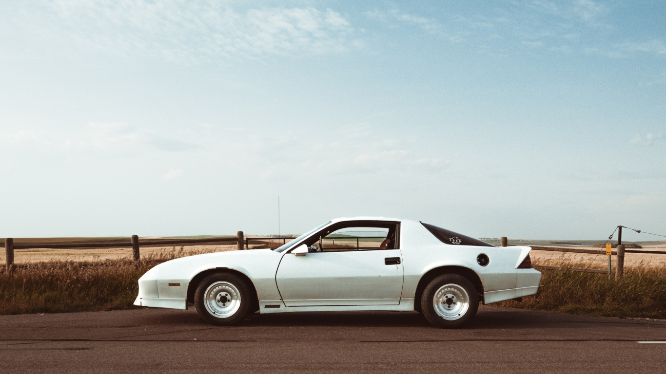 White Coupe on Brown Field Under White Clouds During Daytime. Wallpaper in 1366x768 Resolution