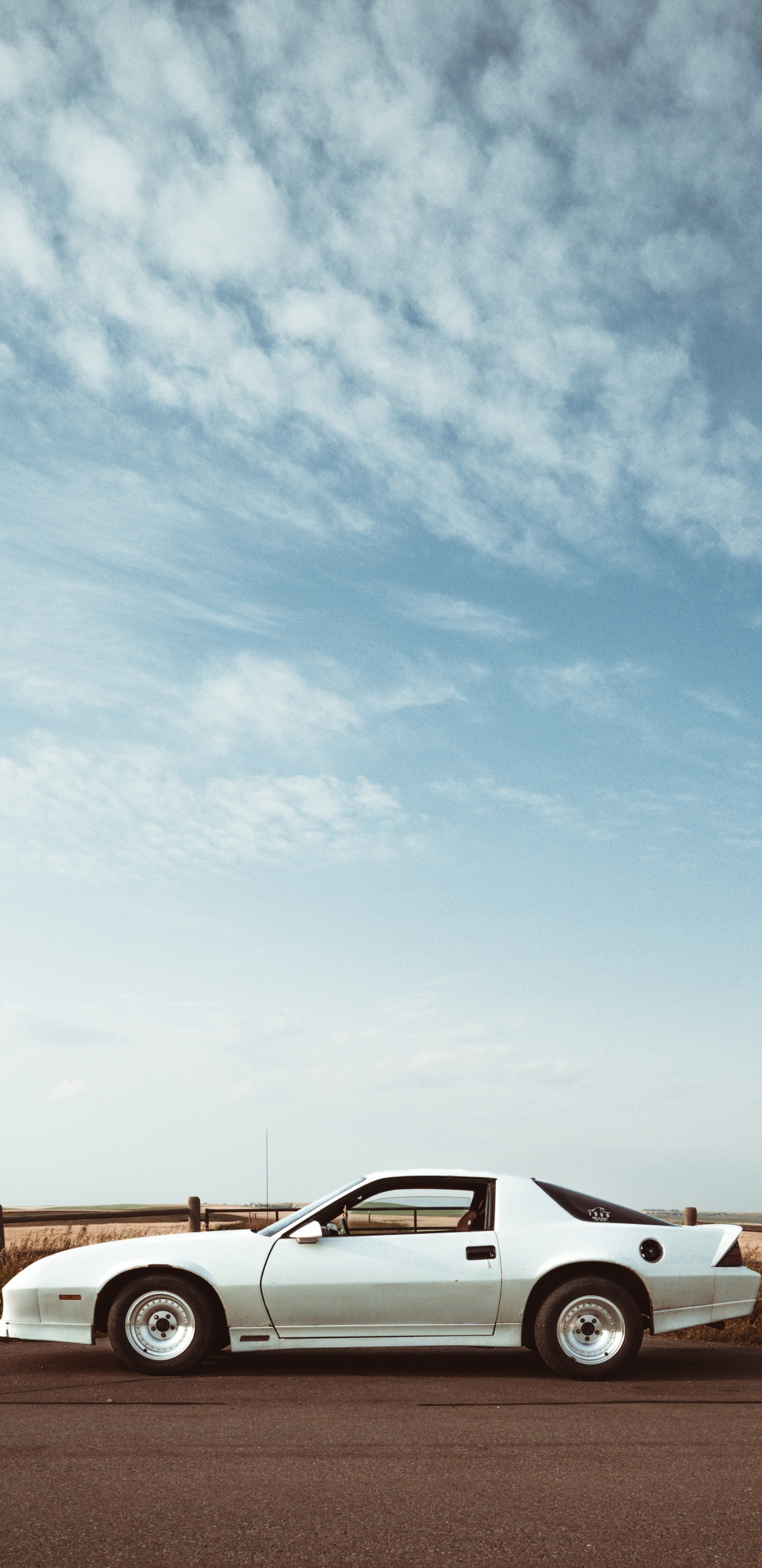 White Coupe on Brown Field Under White Clouds During Daytime. Wallpaper in 1440x2960 Resolution