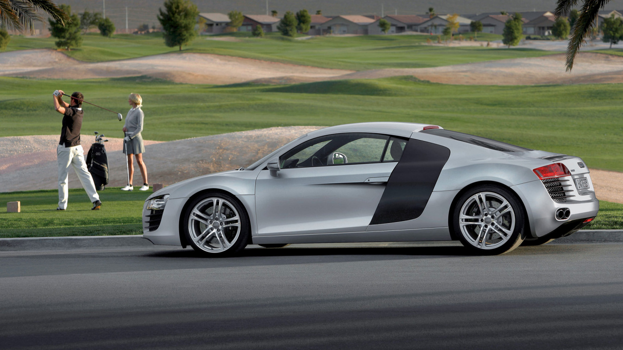 Mann in Weißem T-Shirt Und Weißen Shorts, Der Tagsüber Neben Dem Silbernen Porsche 911 Coupé Steht. Wallpaper in 1280x720 Resolution