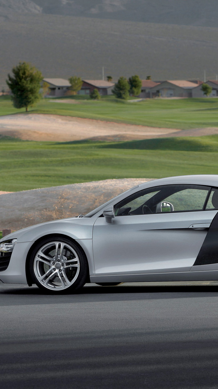 Man in White T-shirt and White Shorts Standing Beside Silver Porsche 911 Coupe During Daytime. Wallpaper in 750x1334 Resolution