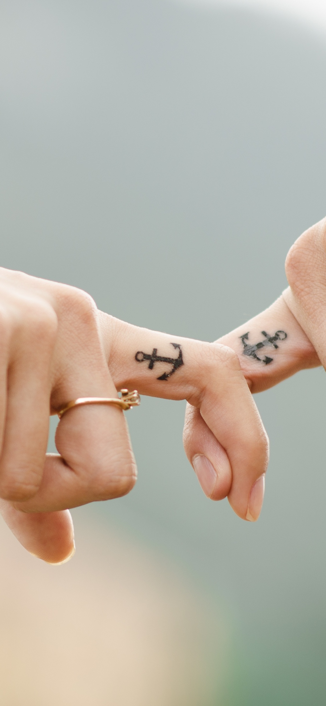 Person Holding Hands of Another Person. Wallpaper in 1125x2436 Resolution