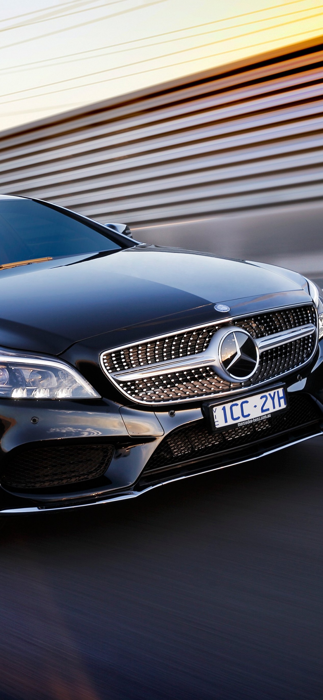 Brown Mercedes Benz Coupe on Road. Wallpaper in 1125x2436 Resolution