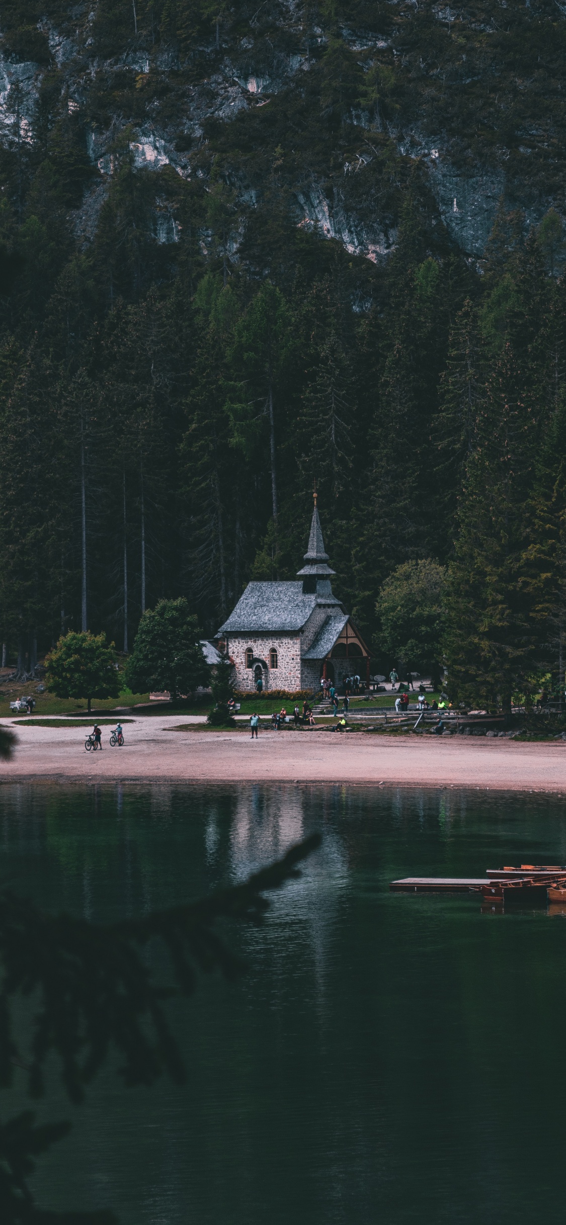 White and Gray House Near Body of Water and Green Trees During Daytime. Wallpaper in 1125x2436 Resolution