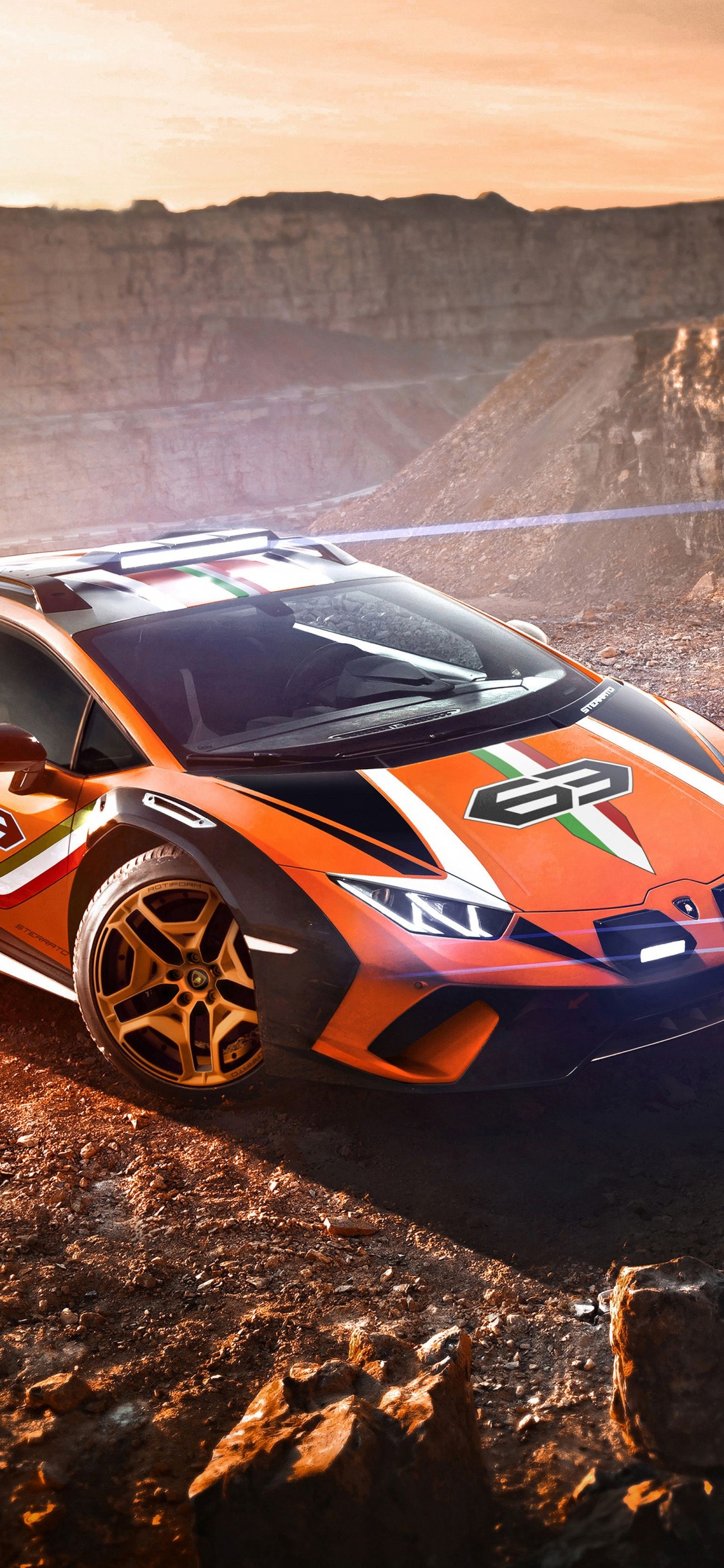 Blue and White Porsche 911 on Brown Rocky Mountain During Daytime. Wallpaper in 1125x2436 Resolution