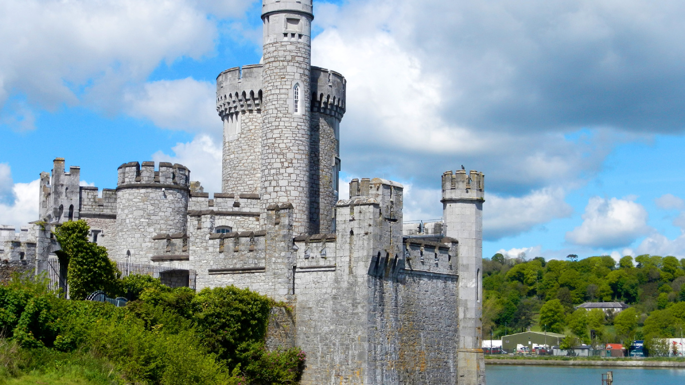 Gray Concrete Castle Near Body of Water During Daytime. Wallpaper in 1366x768 Resolution