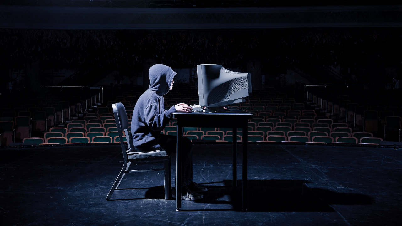Man in Gray Hoodie Sitting on Black Chair. Wallpaper in 1280x720 Resolution