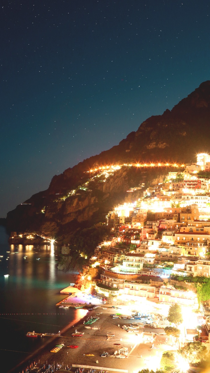 White and Brown Concrete Building Near Body of Water During Night Time. Wallpaper in 720x1280 Resolution
