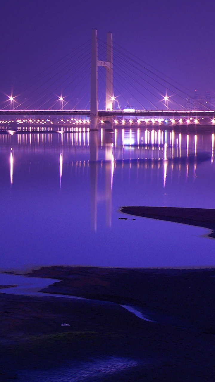 Bridge Over Water During Night Time. Wallpaper in 720x1280 Resolution