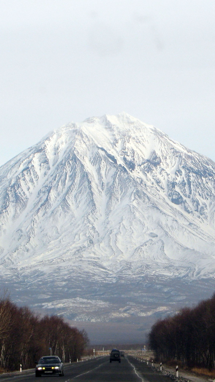 Snow Covered Mountain Under Cloudy Sky During Daytime. Wallpaper in 750x1334 Resolution