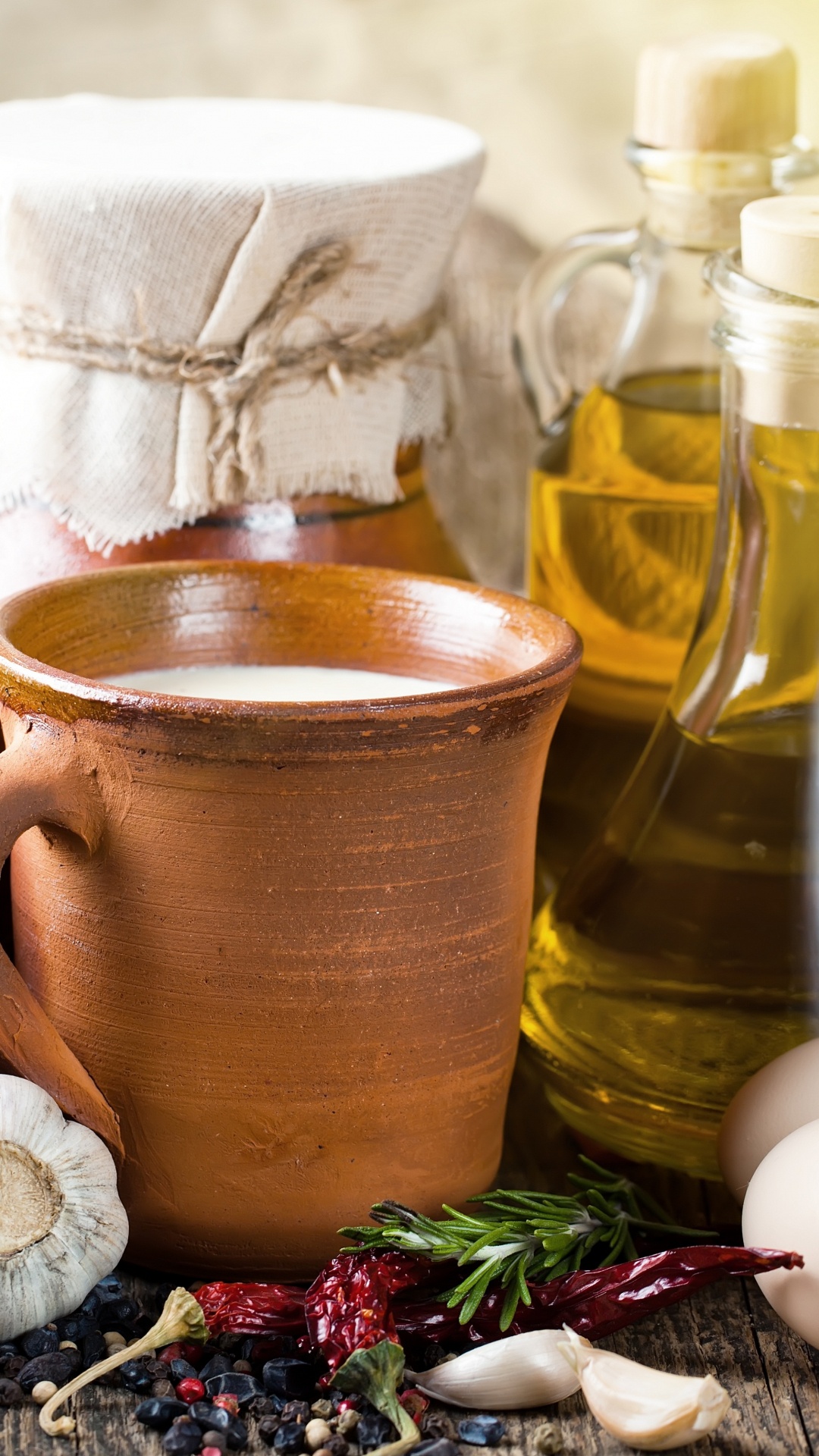 Brown Ceramic Mug Beside Clear Glass Bottle. Wallpaper in 1080x1920 Resolution