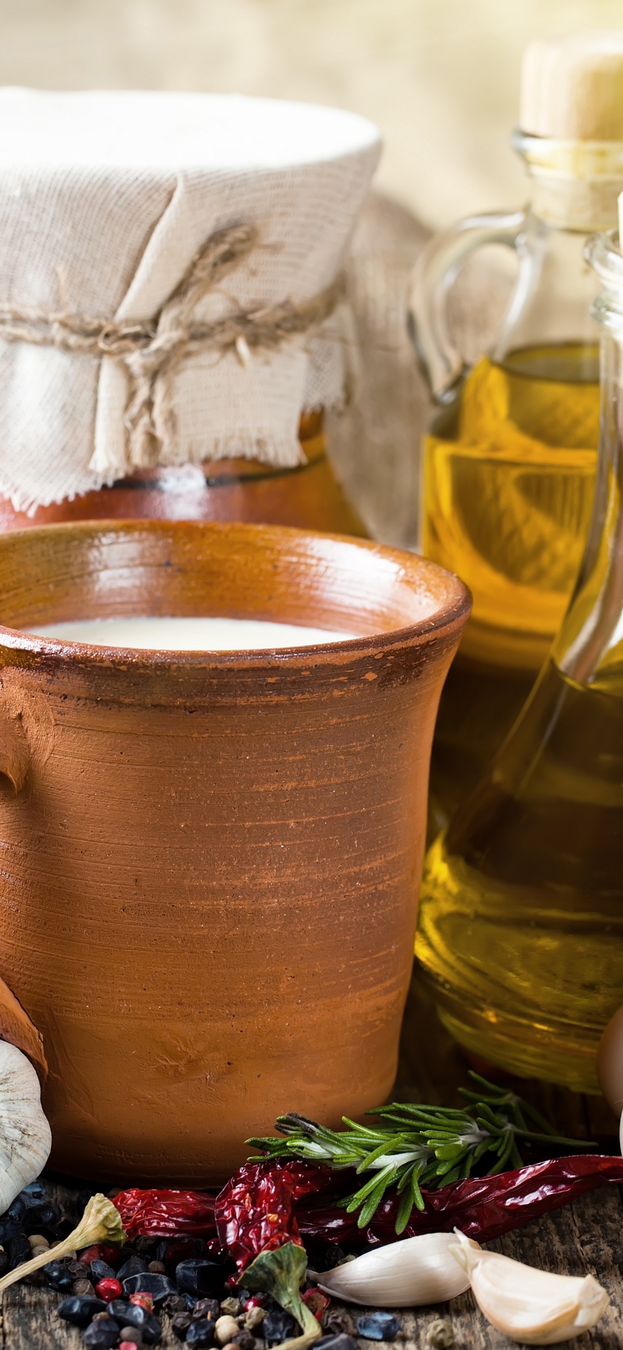 Brown Ceramic Mug Beside Clear Glass Bottle. Wallpaper in 1242x2688 Resolution