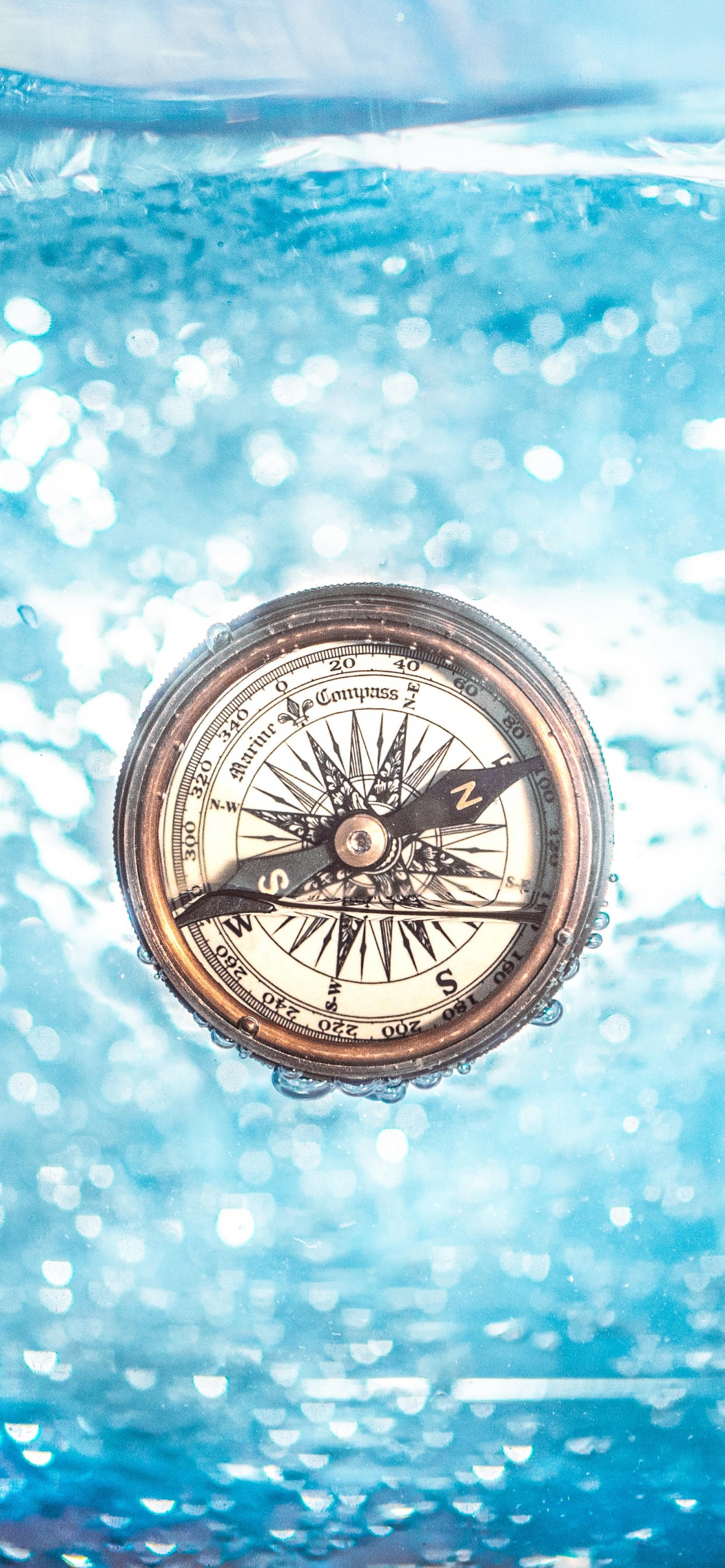 Silver and Black Compass on Blue and White Surface. Wallpaper in 1242x2688 Resolution