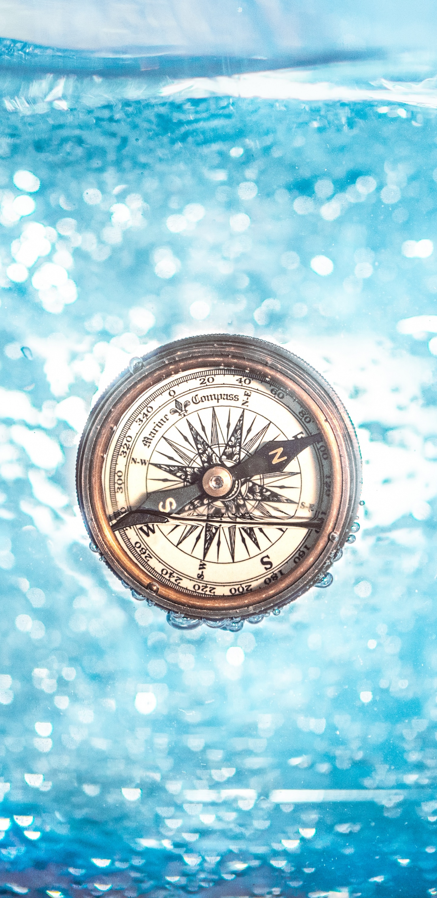 Silver and Black Compass on Blue and White Surface. Wallpaper in 1440x2960 Resolution