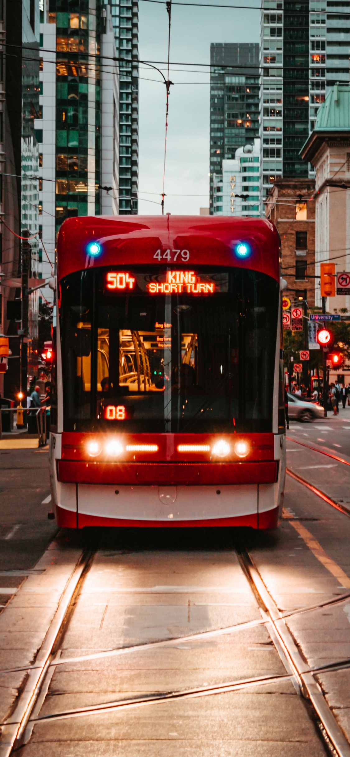 Red and White Tram on Road During Daytime. Wallpaper in 1125x2436 Resolution