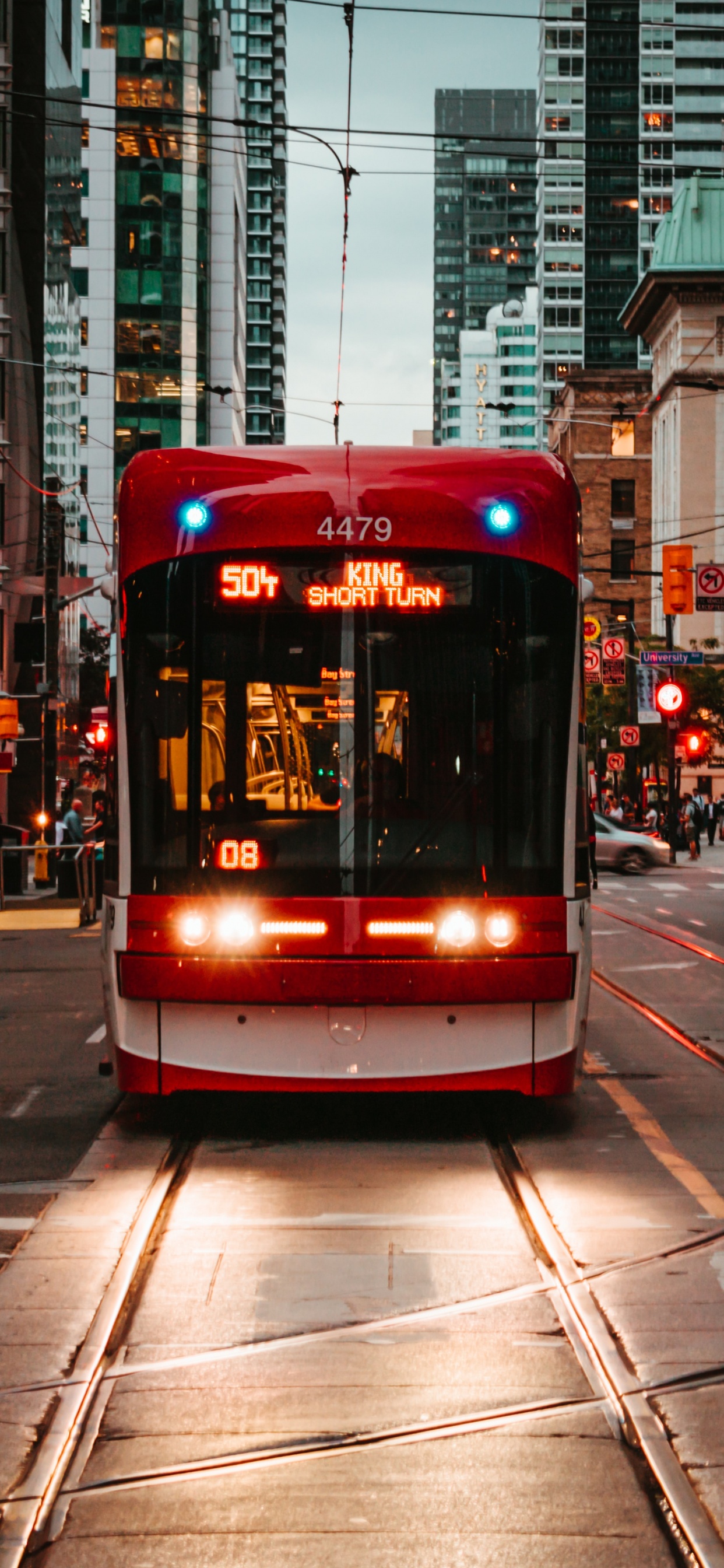 Red and White Tram on Road During Daytime. Wallpaper in 1242x2688 Resolution