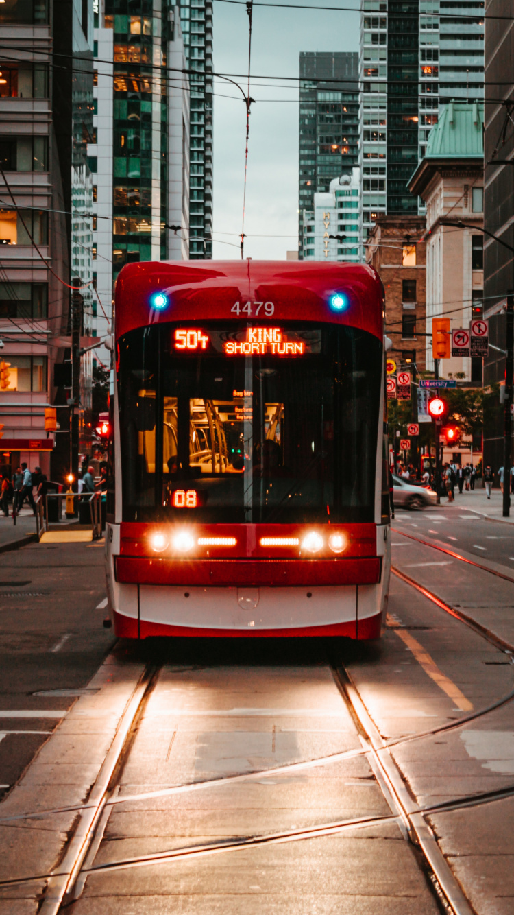 Red and White Tram on Road During Daytime. Wallpaper in 750x1334 Resolution
