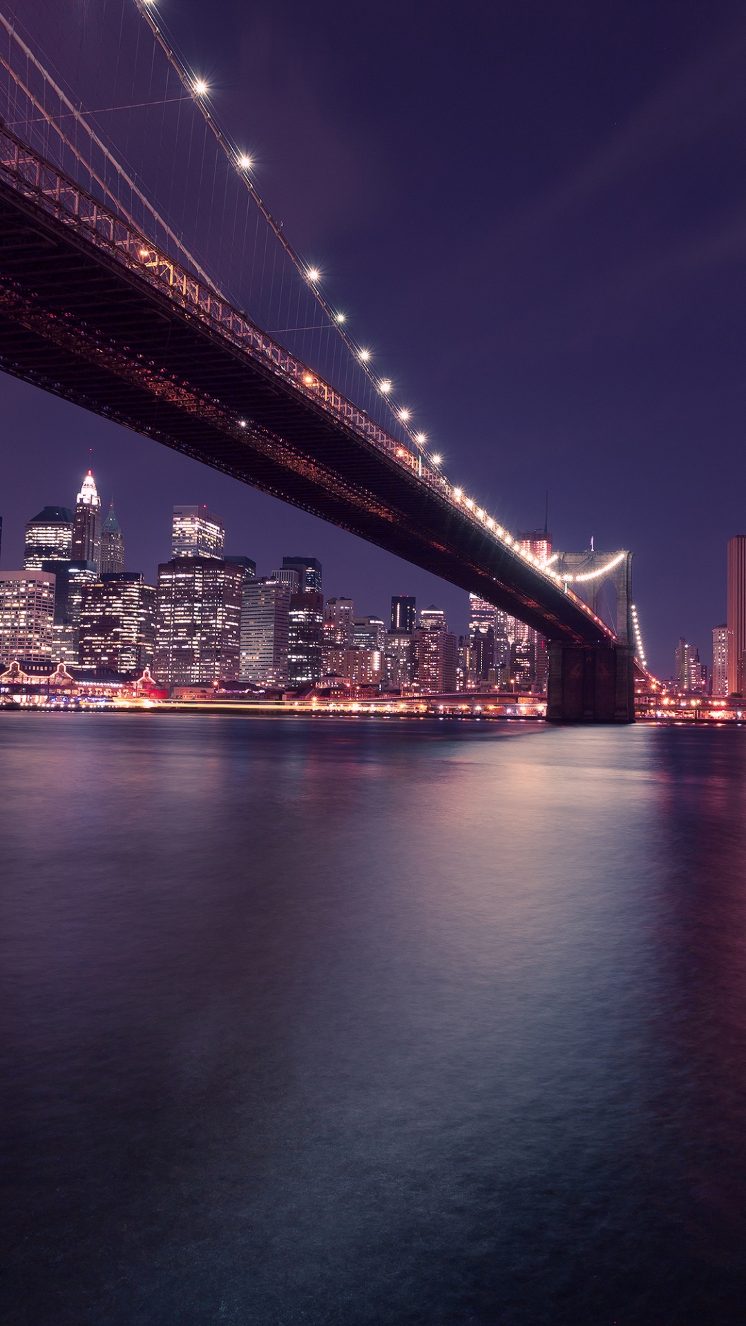 Lighted Bridge Over Body of Water During Night Time. Wallpaper in 1080x1920 Resolution