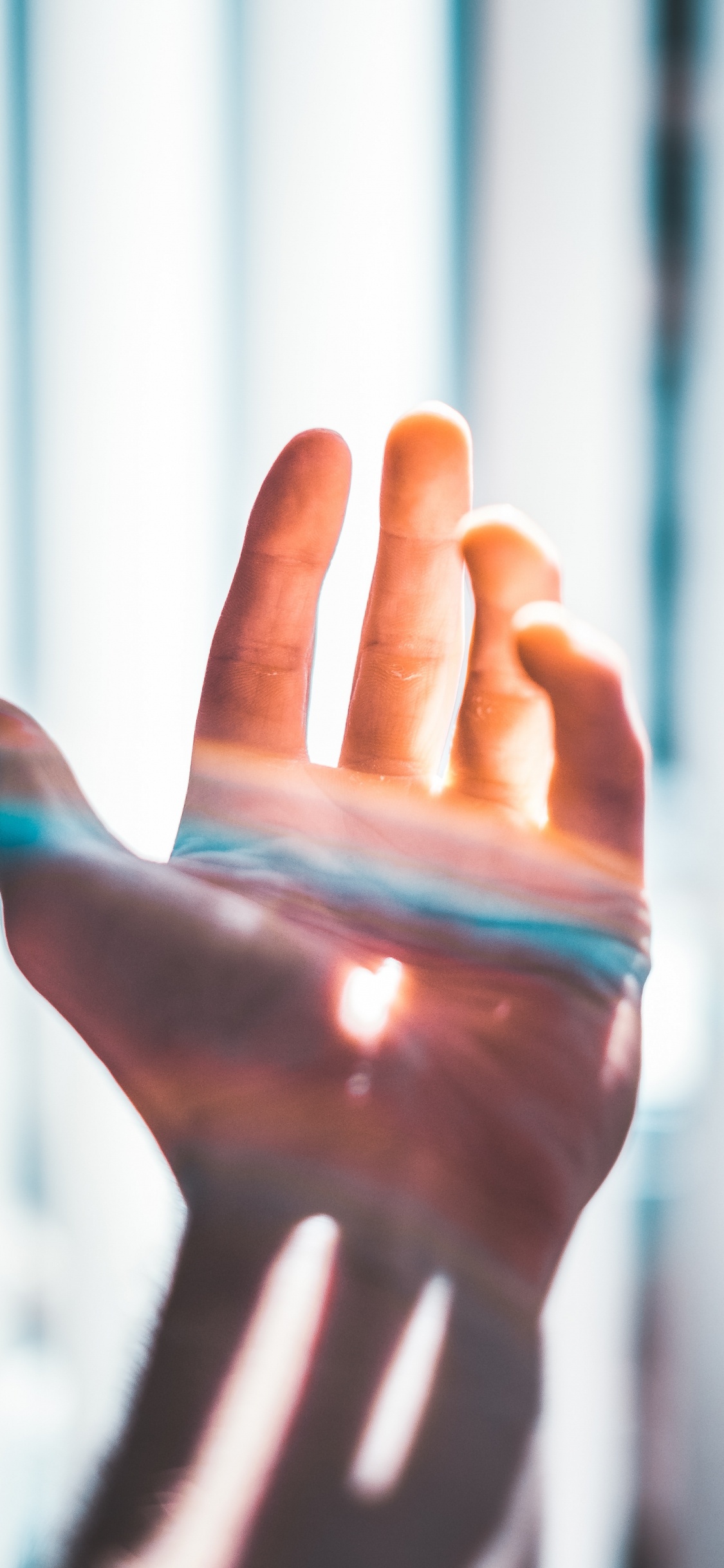 Persons Hand With Blue Paint. Wallpaper in 1125x2436 Resolution