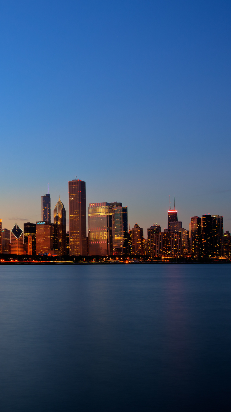 City Skyline Across Body of Water During Daytime. Wallpaper in 750x1334 Resolution