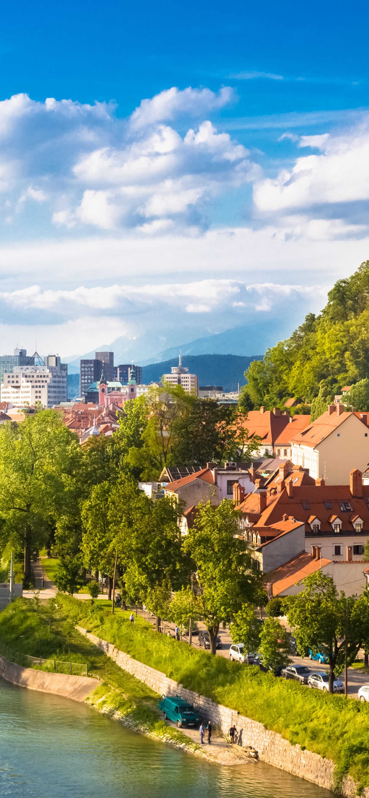 Brown and White Concrete Houses Near River Under Blue Sky During Daytime. Wallpaper in 1242x2688 Resolution