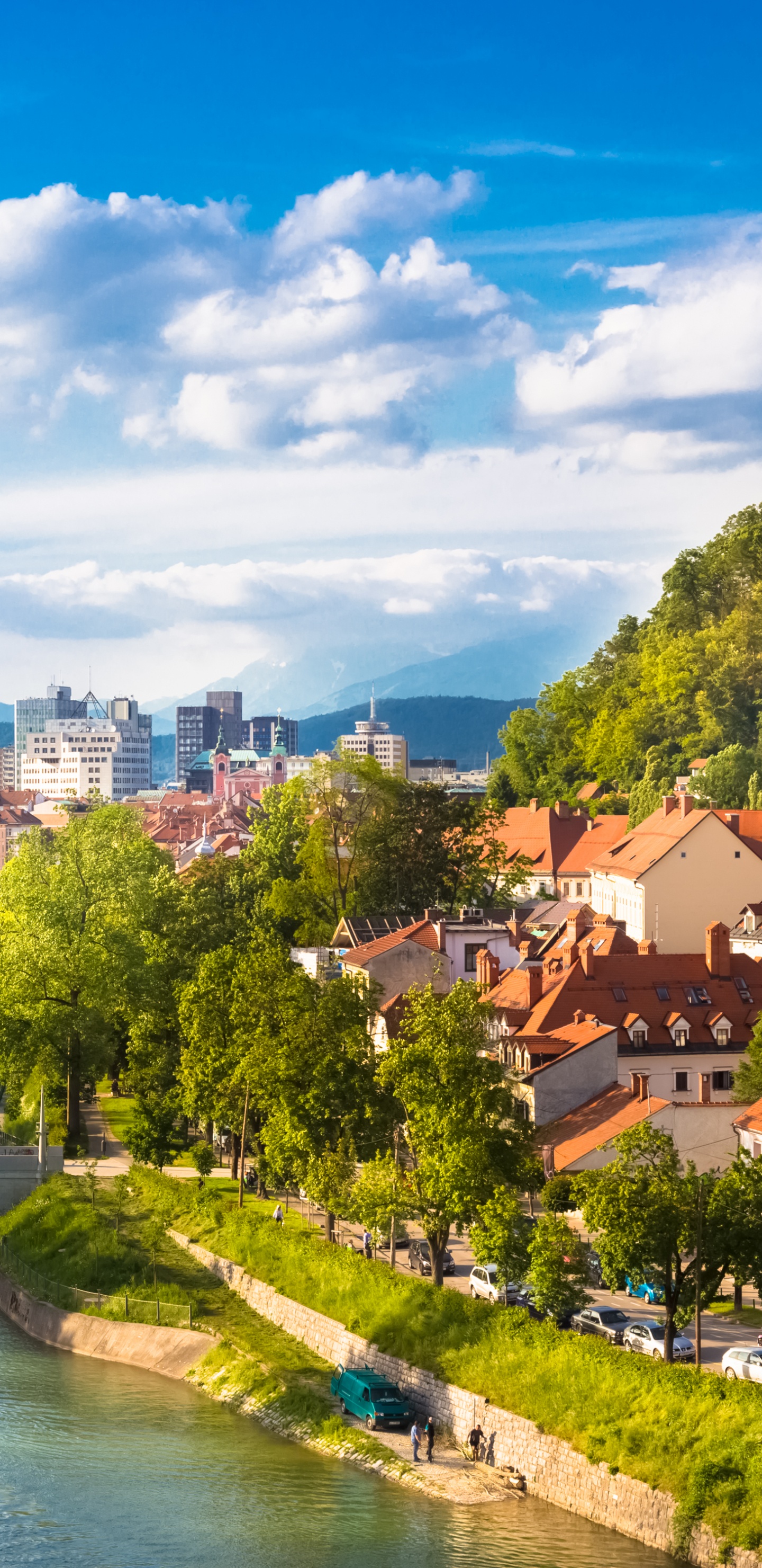 Brown and White Concrete Houses Near River Under Blue Sky During Daytime. Wallpaper in 1440x2960 Resolution