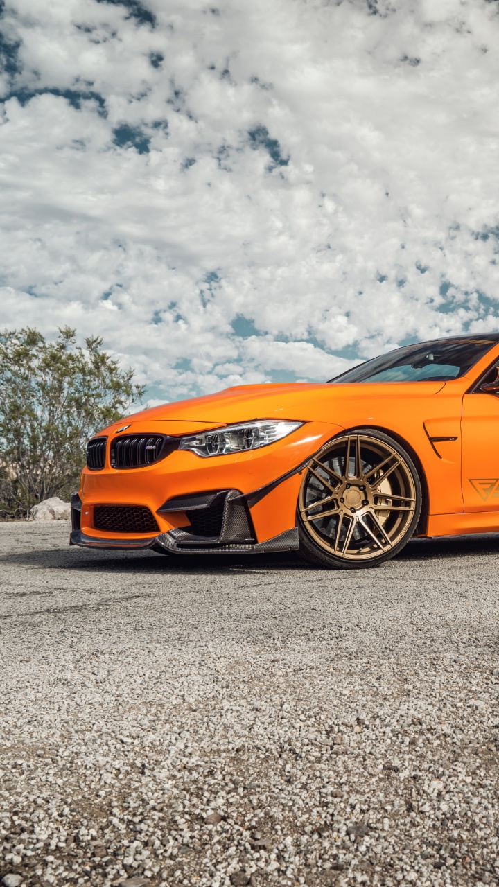 Oranger Porsche 911 Auf Grauem Fels Unter Weißen Wolken Tagsüber During. Wallpaper in 720x1280 Resolution