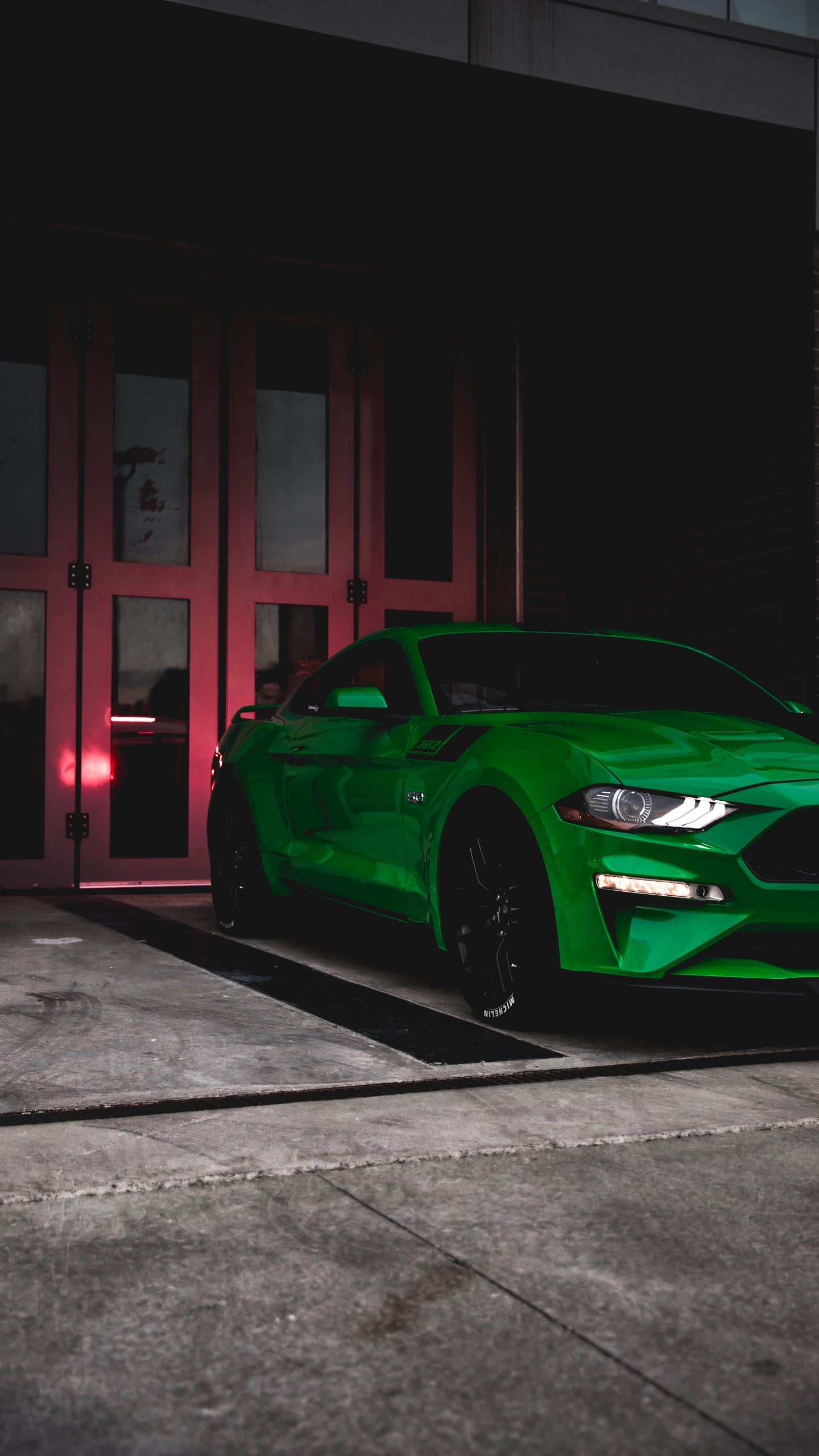 Green Porsche 911 Parked in Front of Brown Wooden Building. Wallpaper in 1440x2560 Resolution