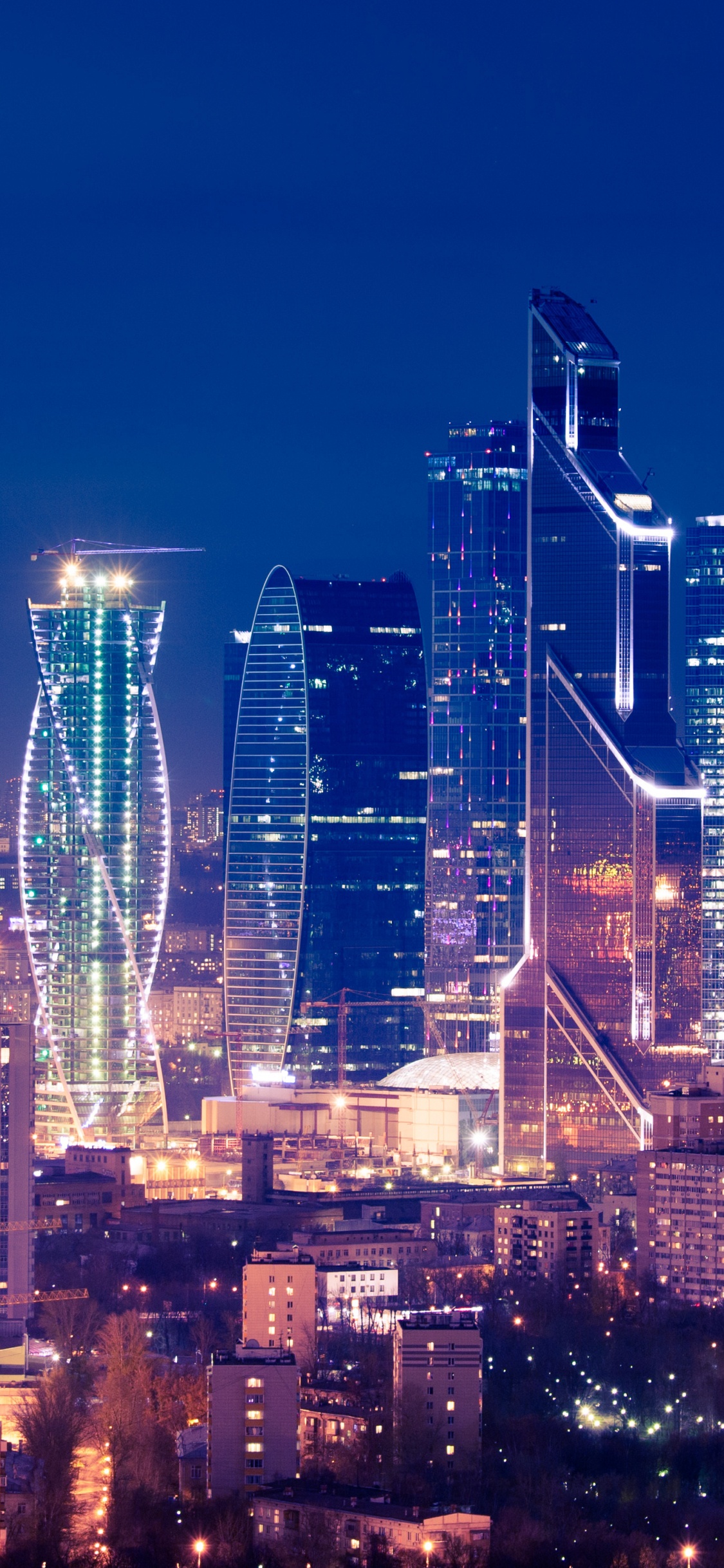 City Skyline During Night Time. Wallpaper in 1125x2436 Resolution