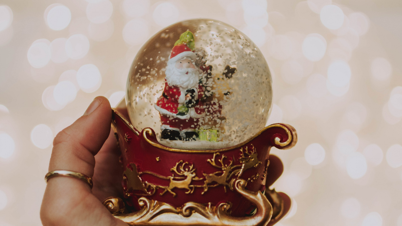 Person Holding White and Red Christmas Bauble. Wallpaper in 1366x768 Resolution