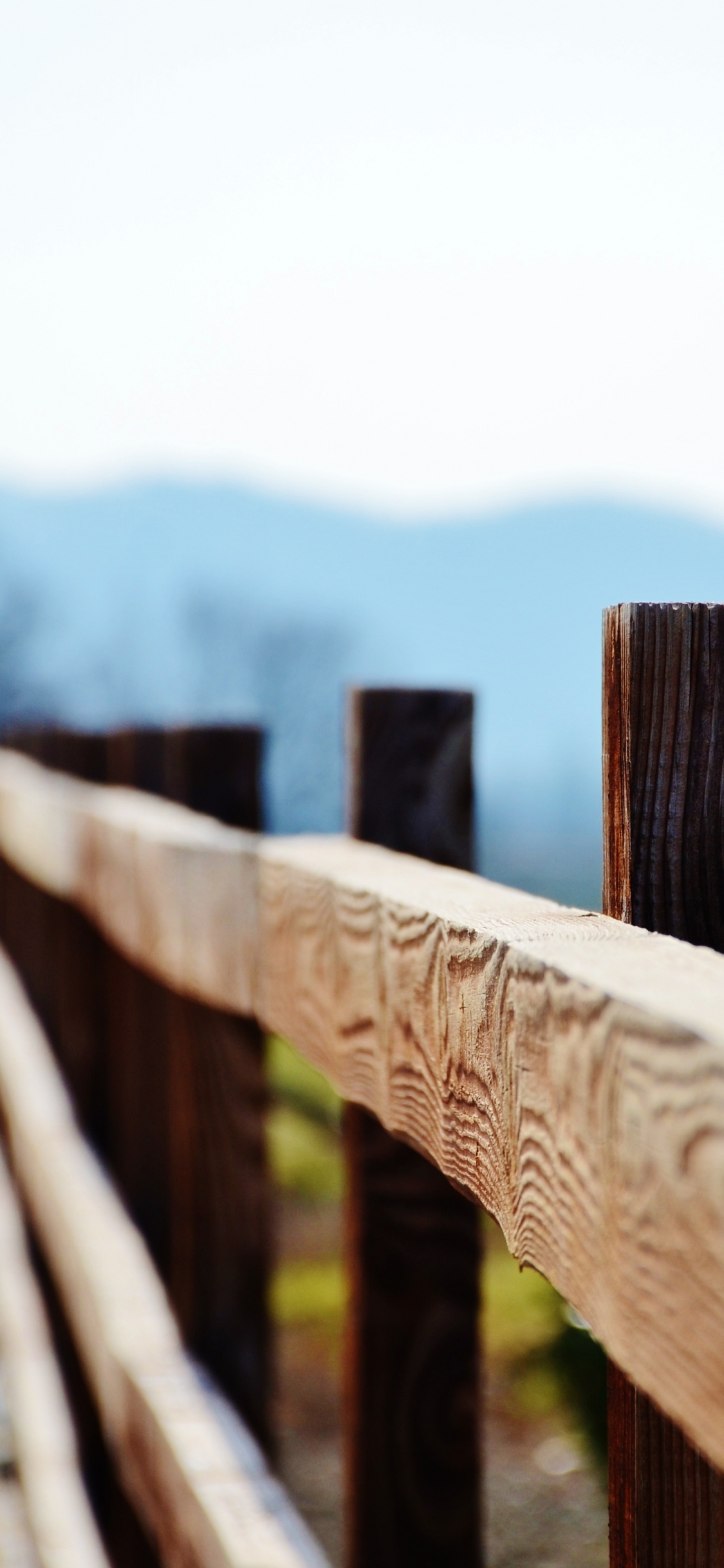 Brown Wooden Fence on Green Grass Field During Daytime. Wallpaper in 1125x2436 Resolution