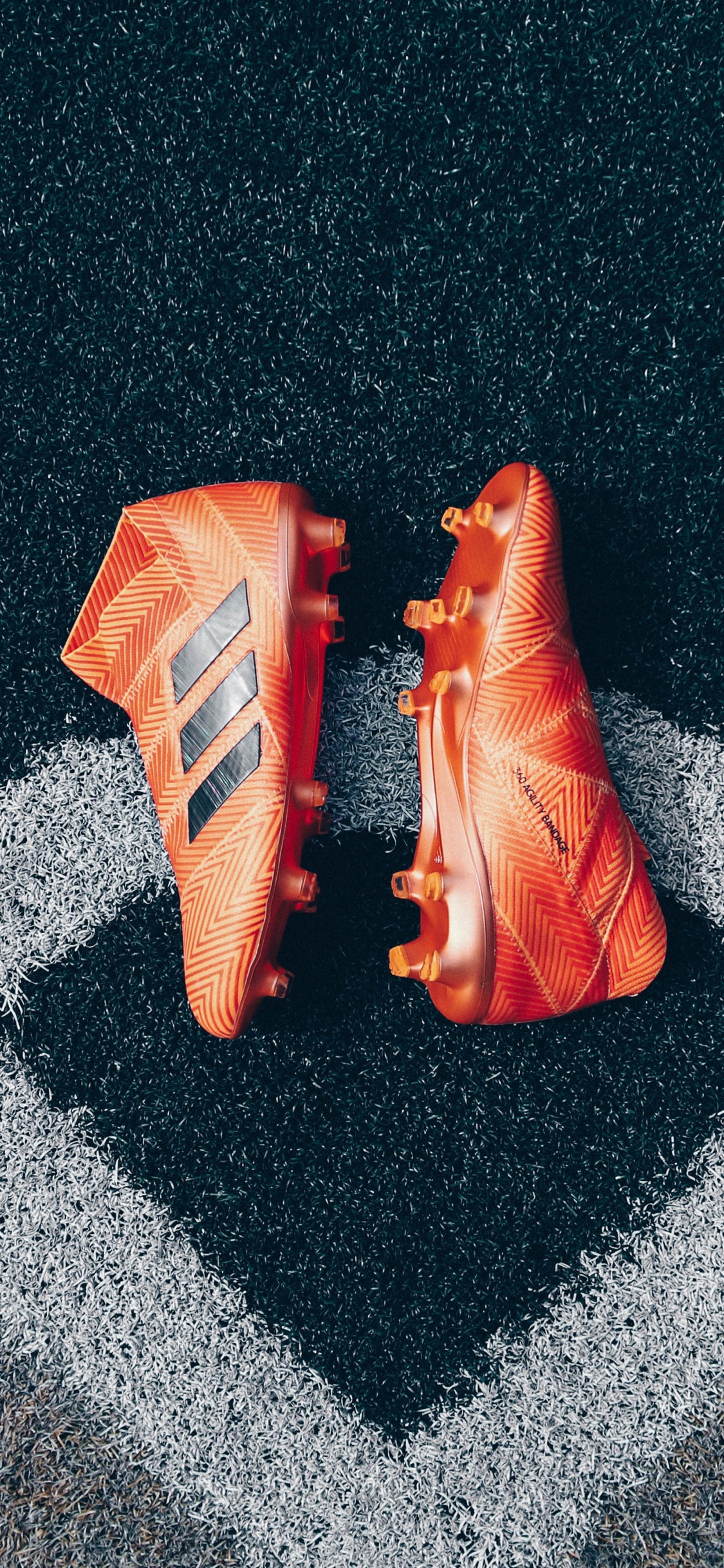 Orange Plastic Pack on Gray and White Textile. Wallpaper in 1125x2436 Resolution