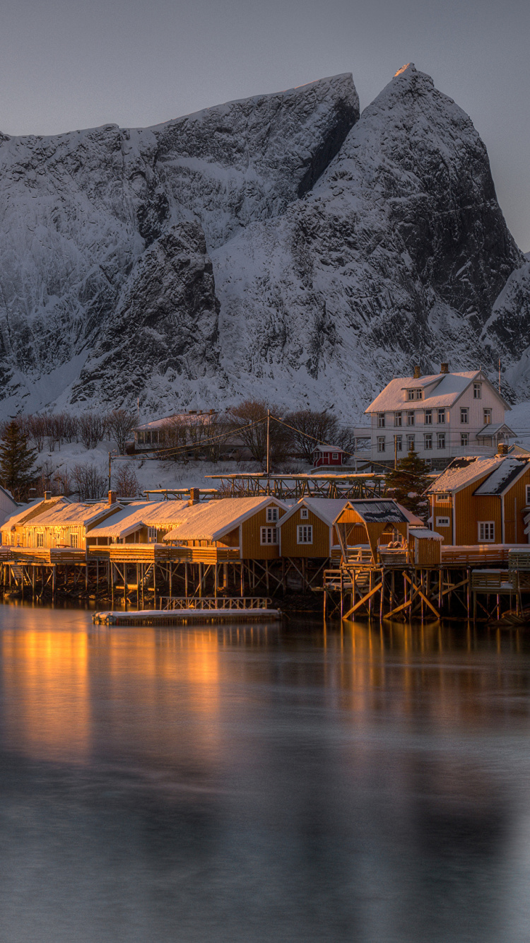 Brown Wooden House on Body of Water Near Gray Mountain During Daytime. Wallpaper in 750x1334 Resolution