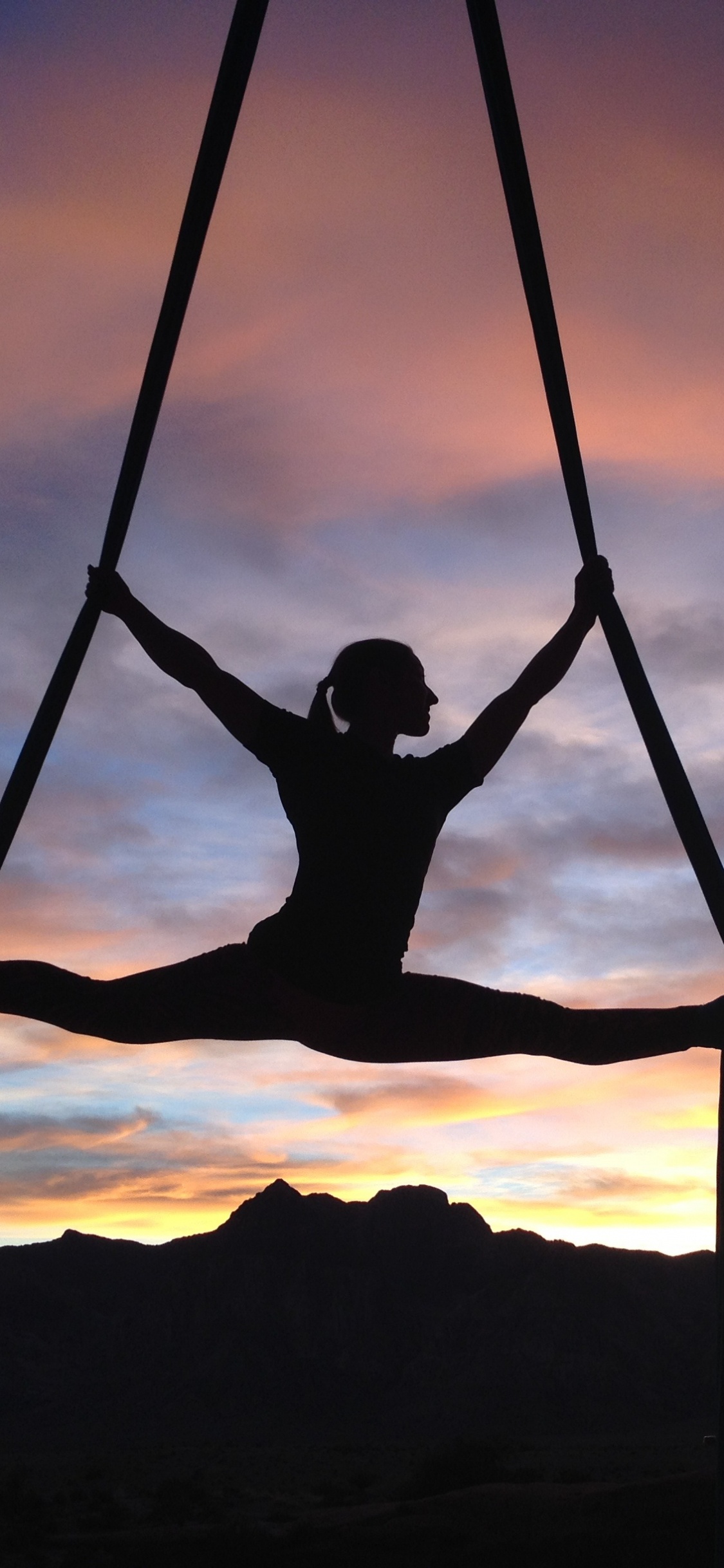 Silhouette of Man Sitting on Swing During Sunset. Wallpaper in 1125x2436 Resolution