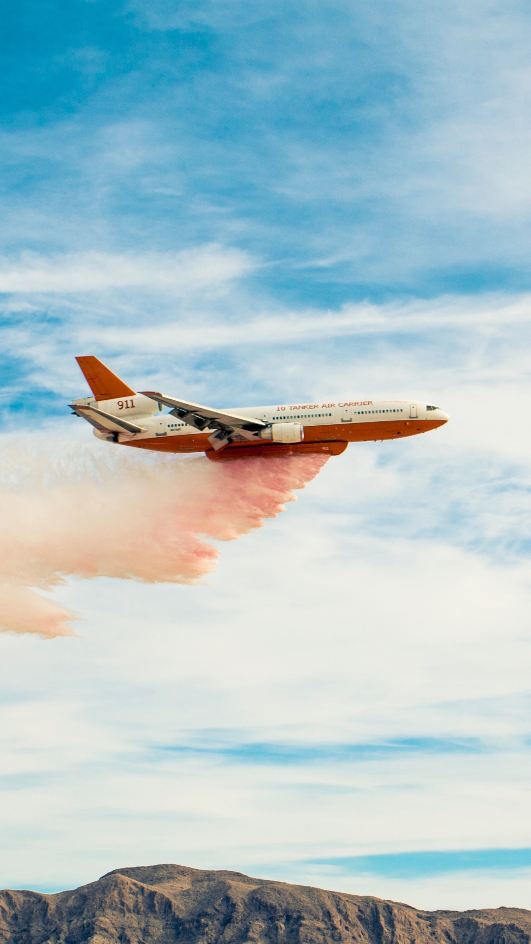 White and Orange Airplane Flying Over The Mountains During Daytime. Wallpaper in 1080x1920 Resolution