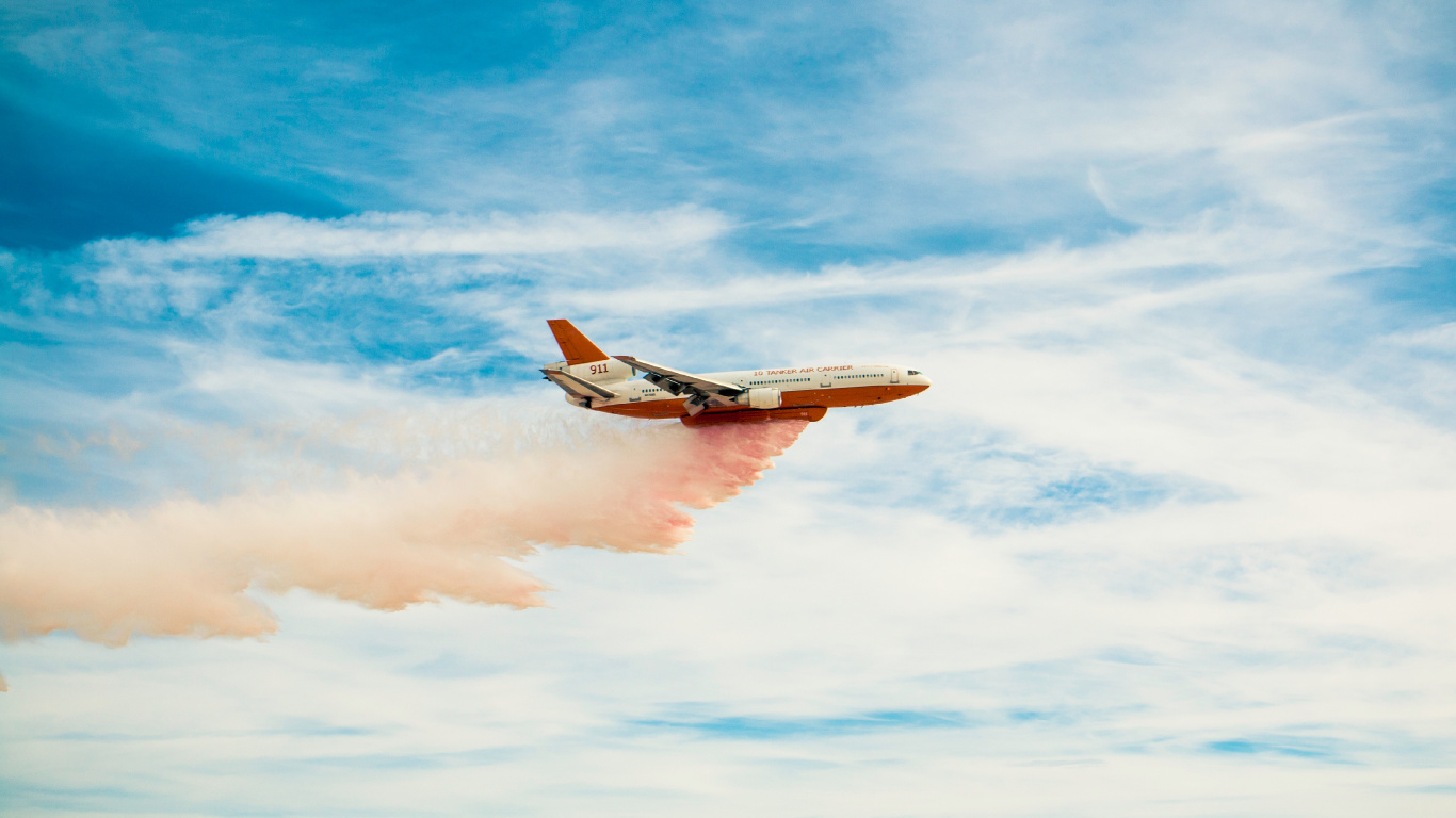 White and Orange Airplane Flying Over The Mountains During Daytime. Wallpaper in 1366x768 Resolution