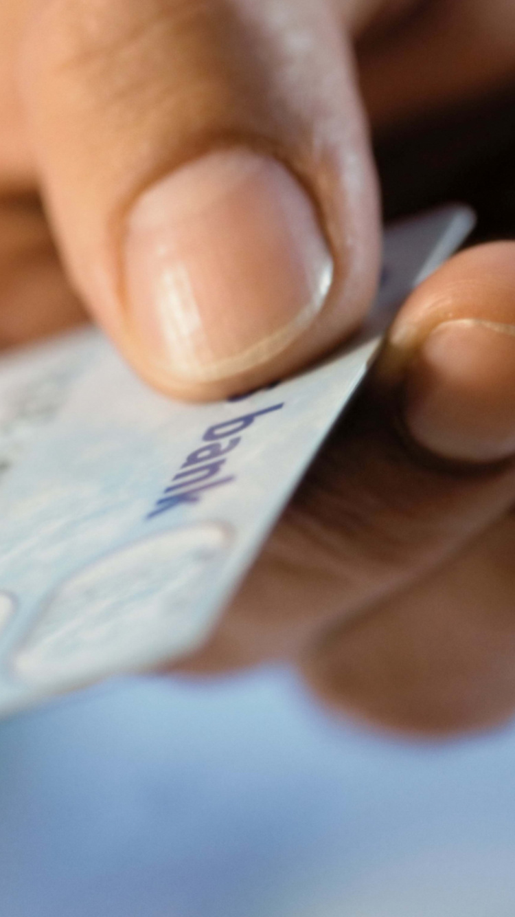 Person Holding White and Blue Card. Wallpaper in 750x1334 Resolution