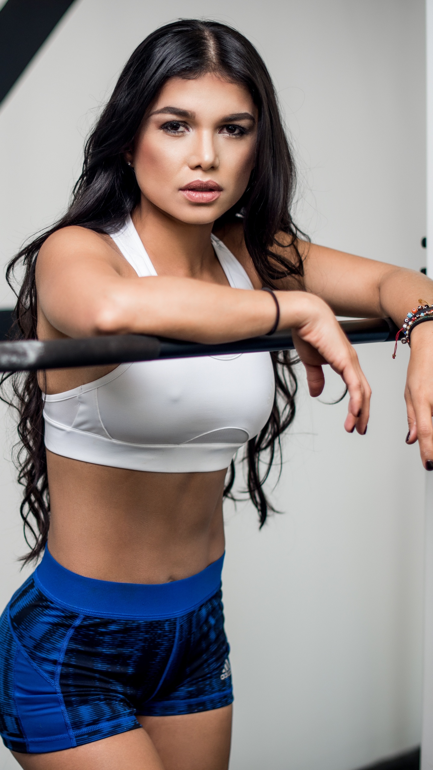 Woman in Blue Denim Shorts Holding Black Dumbbell. Wallpaper in 1440x2560 Resolution