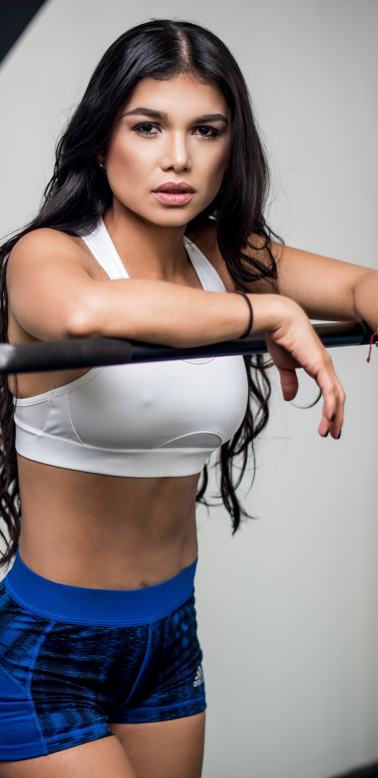 Woman in Blue Denim Shorts Holding Black Dumbbell. Wallpaper in 1440x2960 Resolution