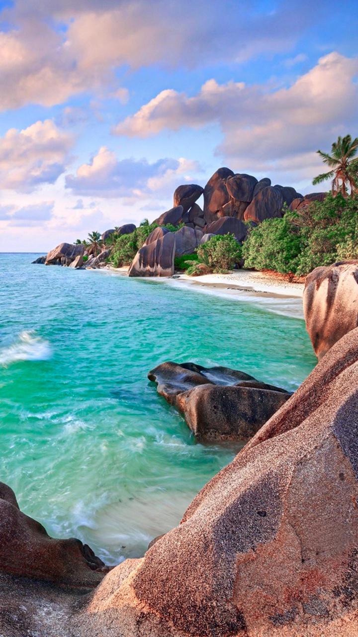 Brown Rock Formation Near Body of Water During Daytime. Wallpaper in 720x1280 Resolution