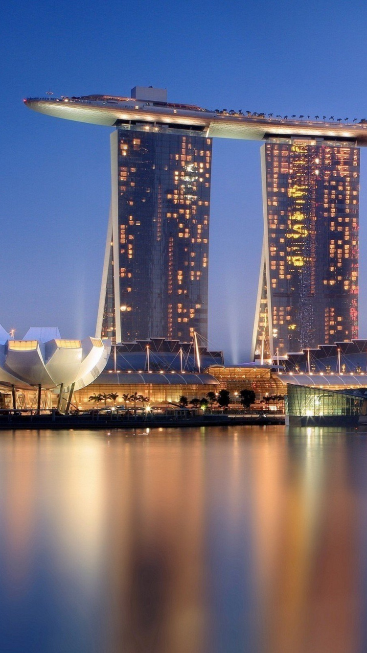 City Skyline Across Body of Water During Night Time. Wallpaper in 750x1334 Resolution