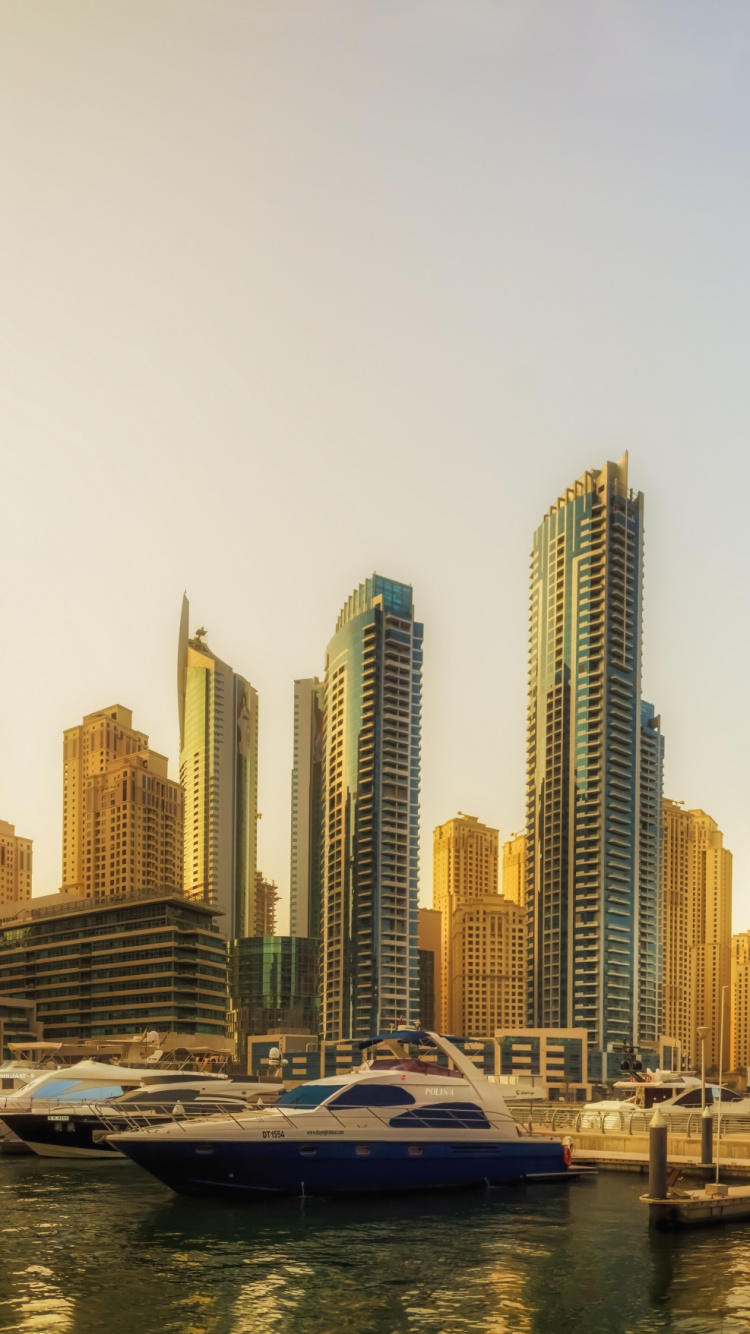 White and Blue Boat on Body of Water Near City Buildings During Daytime. Wallpaper in 750x1334 Resolution