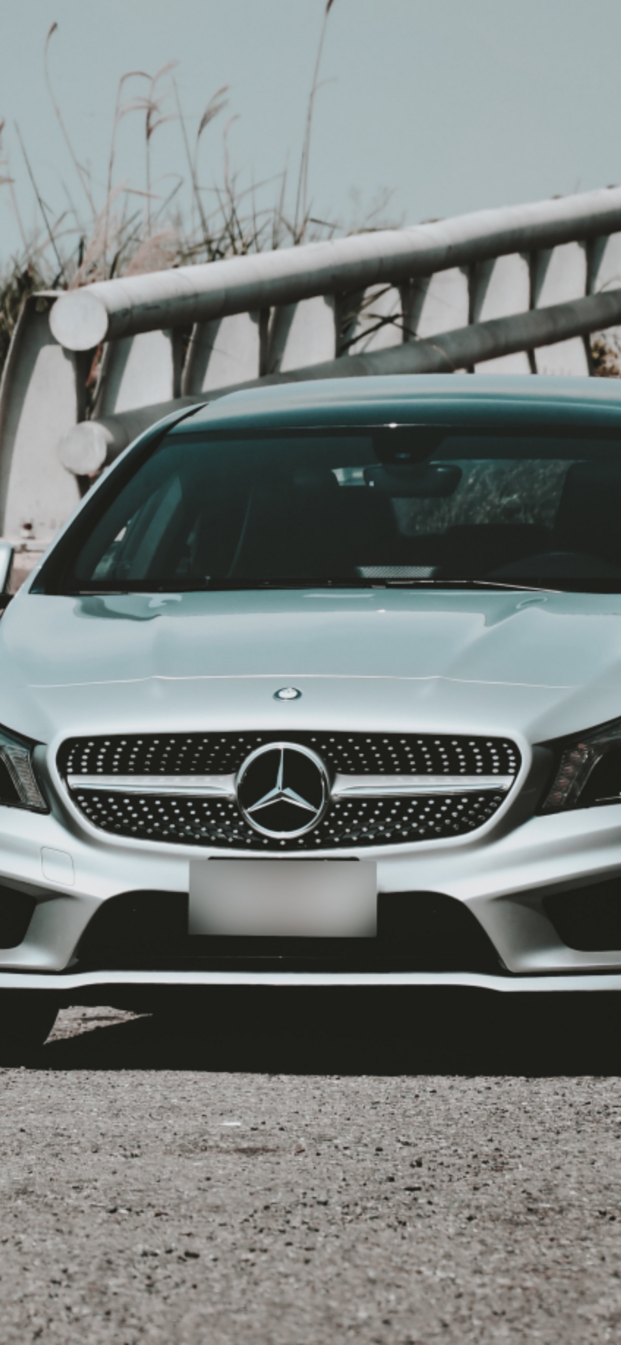 White Mercedes Benz c Class Parked on Gray Sand During Daytime. Wallpaper in 1242x2688 Resolution